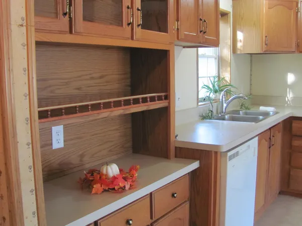 a kitchen with a refrigerator and cabinets