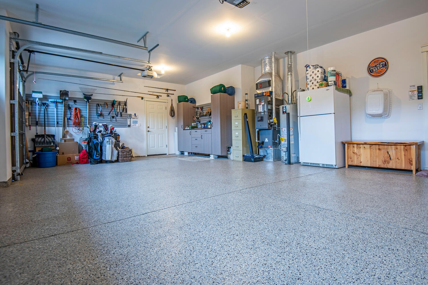 2630 Northwest Boulder Ridge Loop Bend, OR 97703 - Photo 30 of 31 3-car garage with non-slip epoxy floors, workbench, wall tool organizer, storage cabinets.