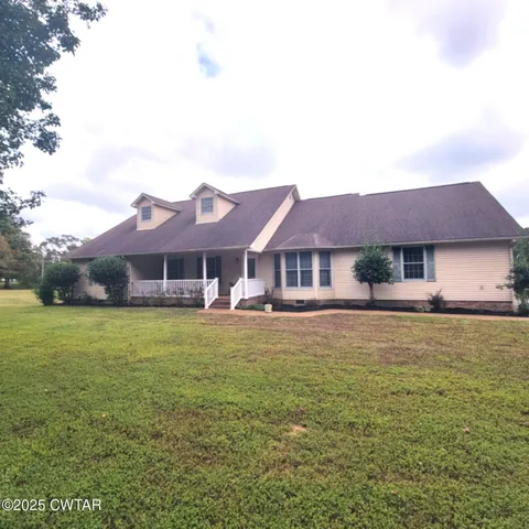 a view of lake with green landscape