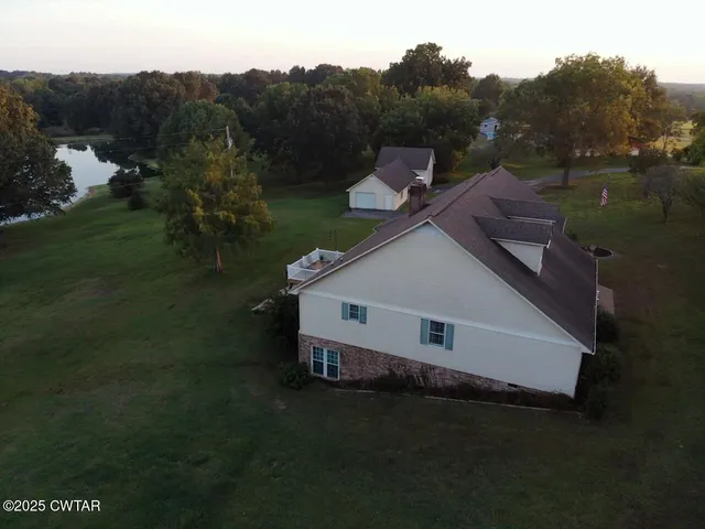 an aerial view of a house having yard garden and lake view