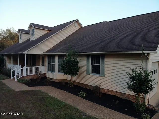a living room with patio furniture and a floor to ceiling window
