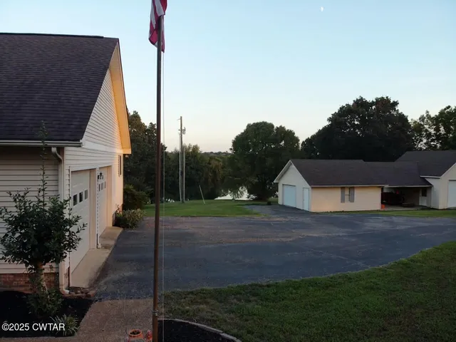 a view of a field with trees in the background