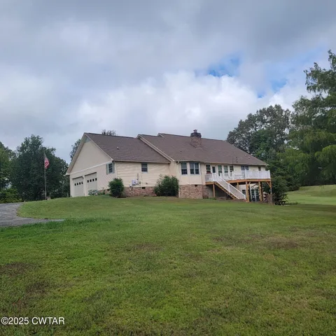 a view of kitchen and a fireplace with wooden floor