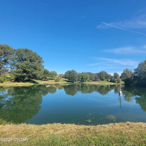 a close view of shoes stand and a shower in back