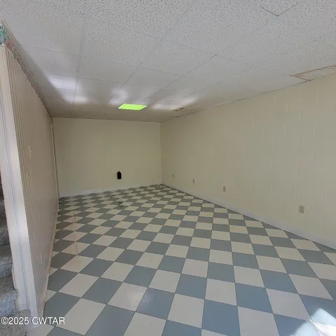 a dining room with a wooden table and chairs