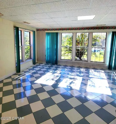 a dining room with furniture and flowers