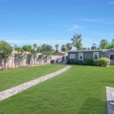 a view of a garden with a house in the background