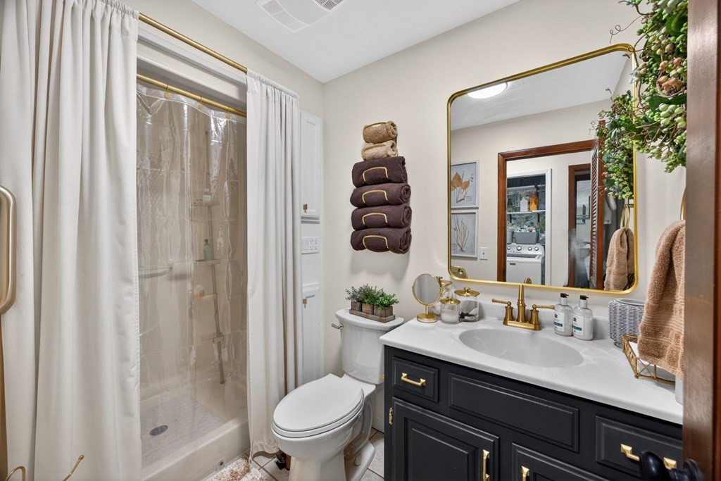 143 Griffintown Road Sparta, TN 38583 - Photo 23 of 35 a bathroom with a granite countertop sink toilet a mirror and shower