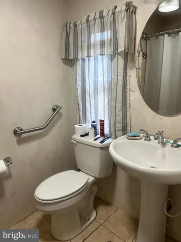 a bedroom with double vanity and a mirror
