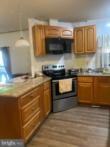 a stove top oven sitting inside of a kitchen