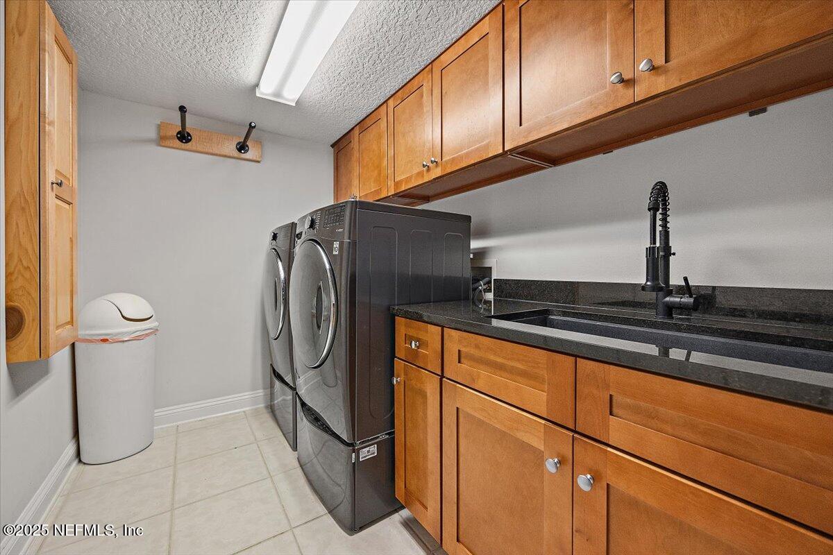 760 Mill Stream Road Ponte Vedra Beach, FL 32082 - Photo 23 of 34 a kitchen with a refrigerator and cabinets