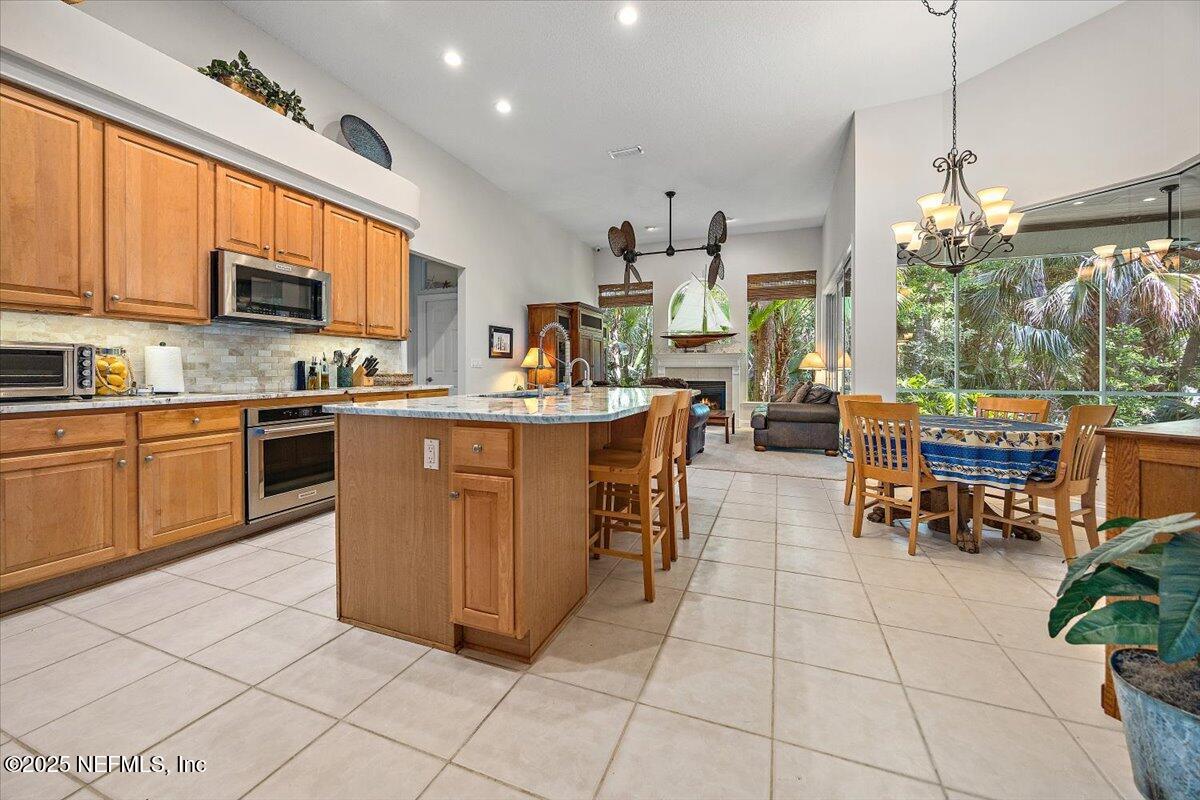 760 Mill Stream Road Ponte Vedra Beach, FL 32082 - Photo 6 of 34 a kitchen with stainless steel appliances granite countertop a sink a stove top oven a counter space and cabinets