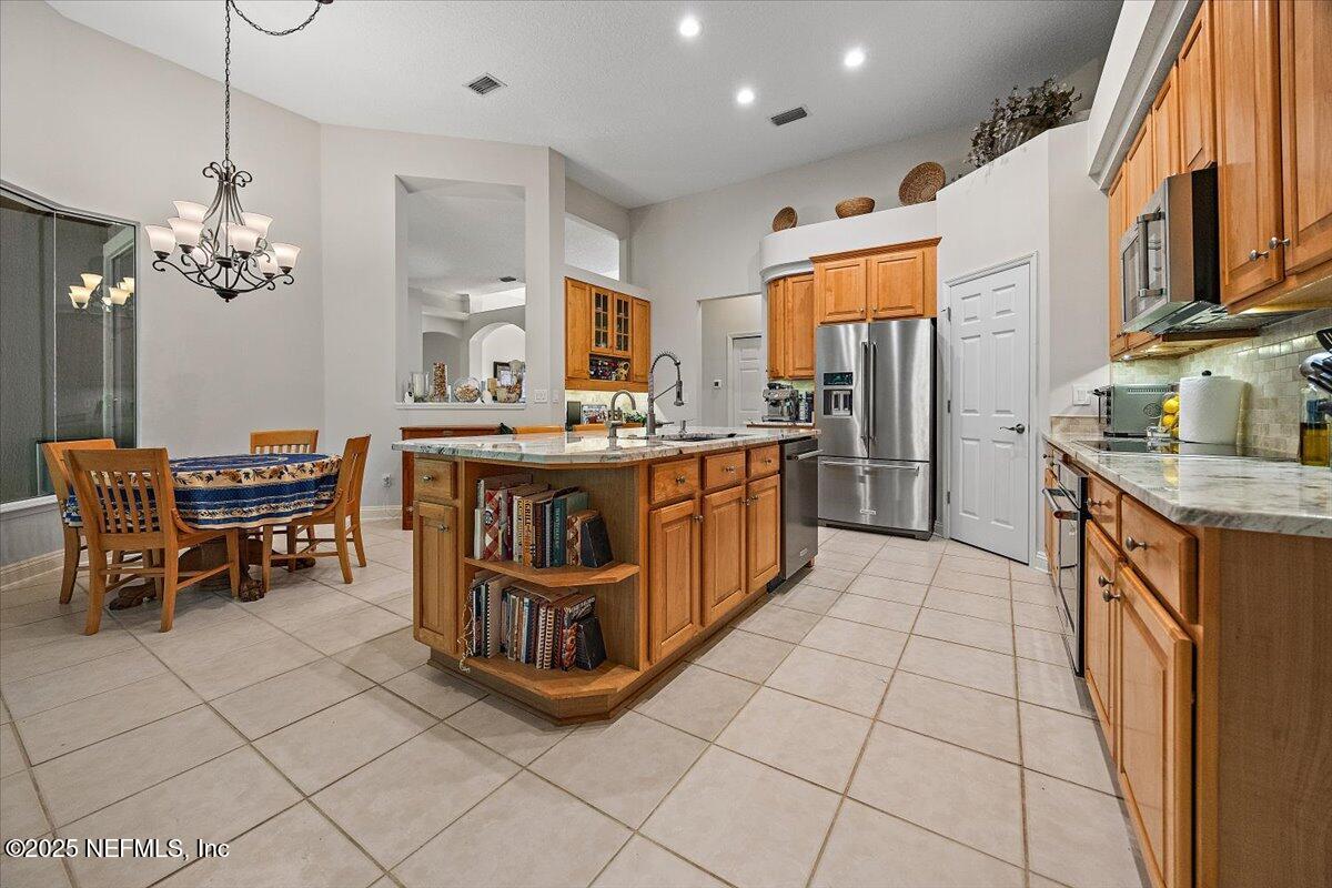 760 Mill Stream Road Ponte Vedra Beach, FL 32082 - Photo 8 of 34 a kitchen with stainless steel appliances granite countertop a stove a sink a oven and a refrigerator
