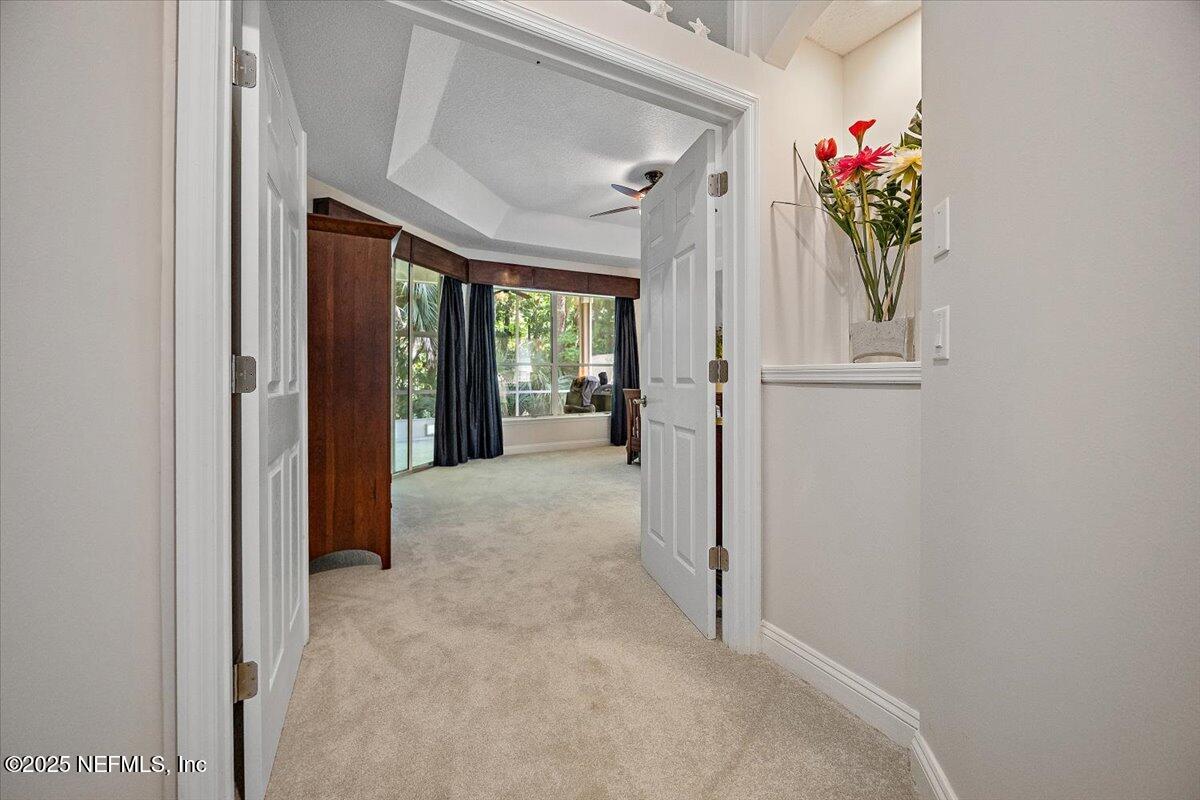 760 Mill Stream Road Ponte Vedra Beach, FL 32082 - Photo 10 of 34 a view of hallway with furniture and a chandelier