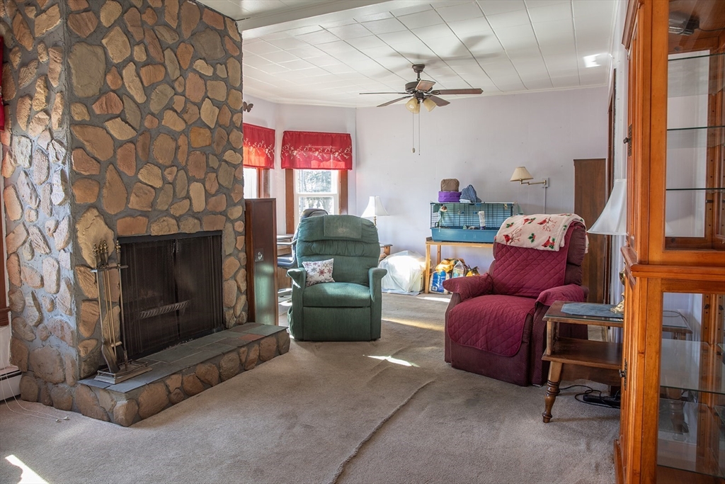 118 Oak Street Springfield, MA 01151 - Photo 11 of 32 a living room with furniture a flat screen tv and a fireplace