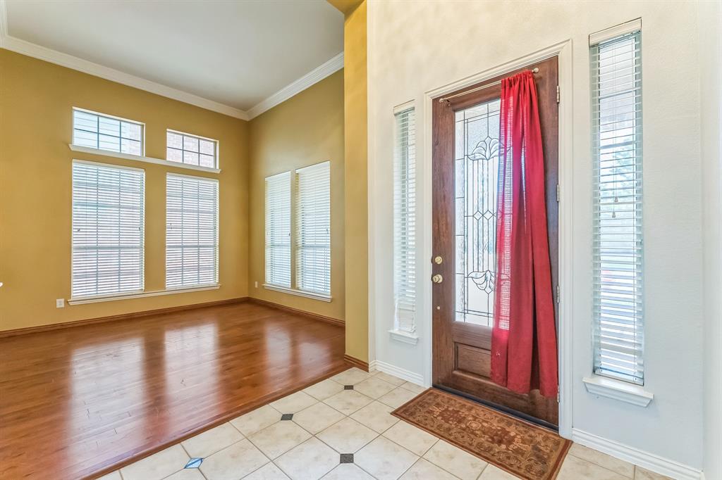 1611 Long Prairie Court Allen, TX 75002 - Photo 12 of 32 a view of a room with wooden floor and windows