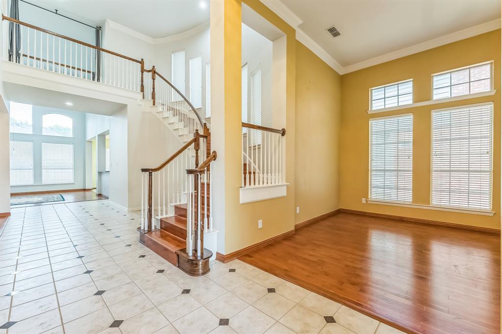 1611 Long Prairie Court Allen, TX 75002 - Photo 13 of 32 a view of entryway with stairs and wooden floor