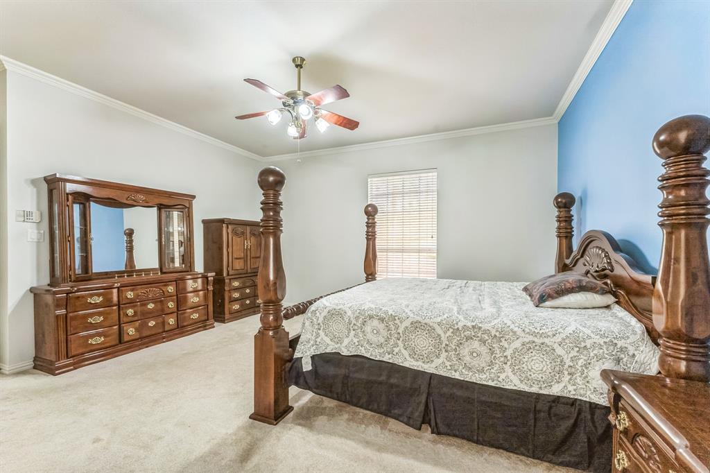 1611 Long Prairie Court Allen, TX 75002 - Photo 15 of 32 a bedroom with a bed dresser and wooden floor