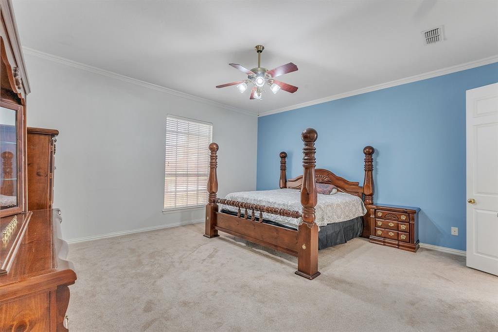 1611 Long Prairie Court Allen, TX 75002 - Photo 16 of 32 a spacious bedroom with a bed and a chandelier