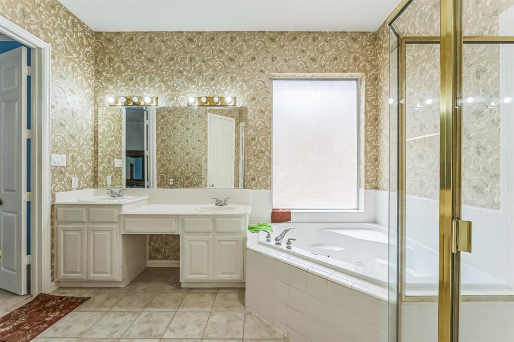 1611 Long Prairie Court Allen, TX 75002 - Photo 18 of 32 a bathroom with a tub sink and mirror
