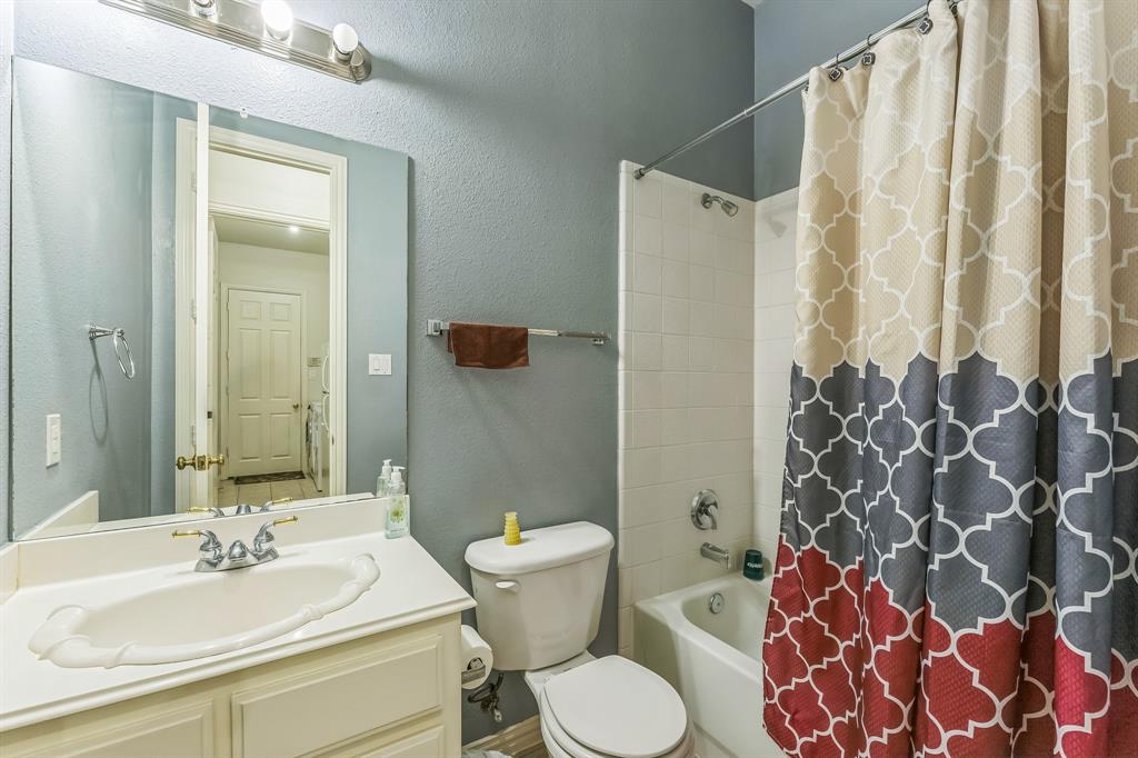 1611 Long Prairie Court Allen, TX 75002 - Photo 20 of 32 a bathroom with a sink and mirror with toilet
