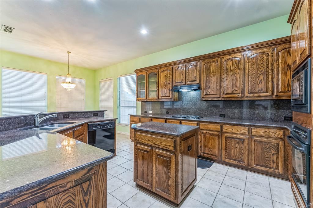 1611 Long Prairie Court Allen, TX 75002 - Photo 2 of 32 a kitchen with stainless steel appliances granite countertop a sink and cabinets
