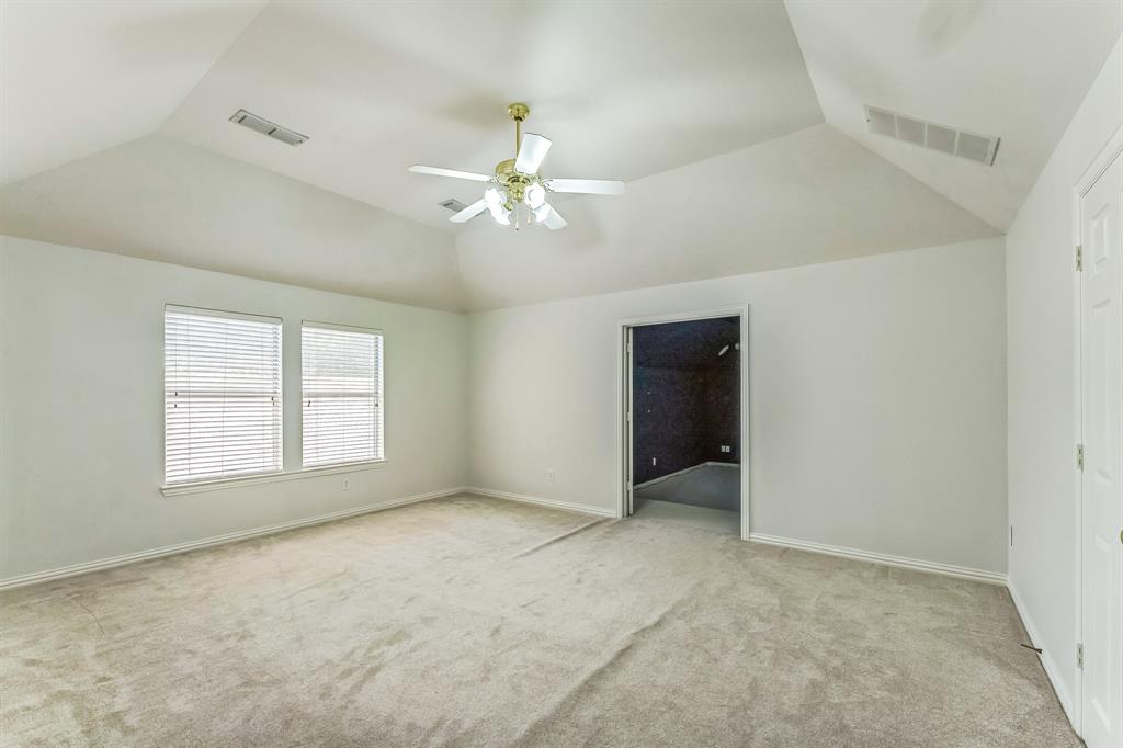 1611 Long Prairie Court Allen, TX 75002 - Photo 22 of 32 an empty room with chandelier fan and windows