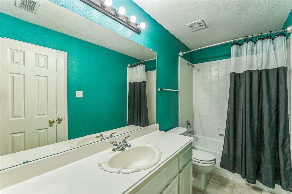 1611 Long Prairie Court Allen, TX 75002 - Photo 26 of 32 a bathroom with a sink toilet and shower