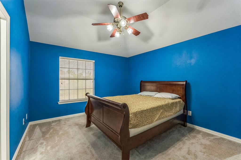 1611 Long Prairie Court Allen, TX 75002 - Photo 28 of 32 a bed sitting in a room next to a window