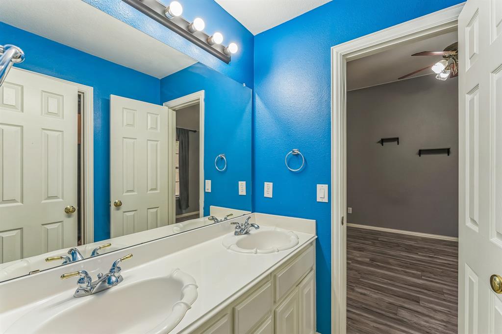 1611 Long Prairie Court Allen, TX 75002 - Photo 30 of 32 a bathroom with a double vanity sink and a mirror