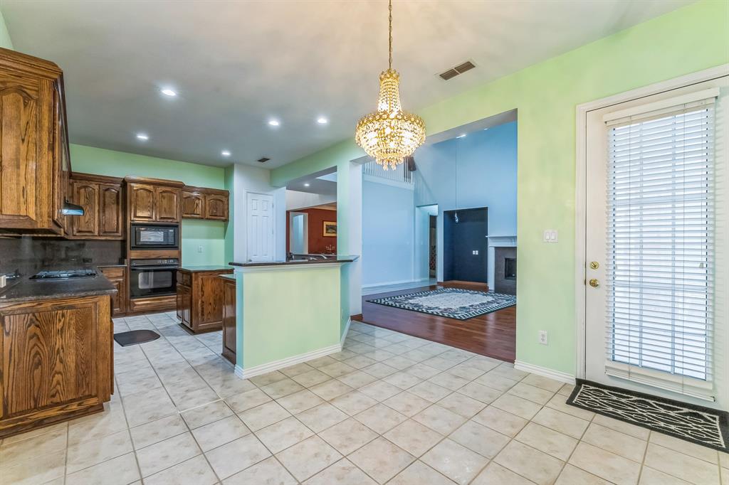 1611 Long Prairie Court Allen, TX 75002 - Photo 3 of 32 a kitchen with stainless steel appliances granite countertop a refrigerator and a sink