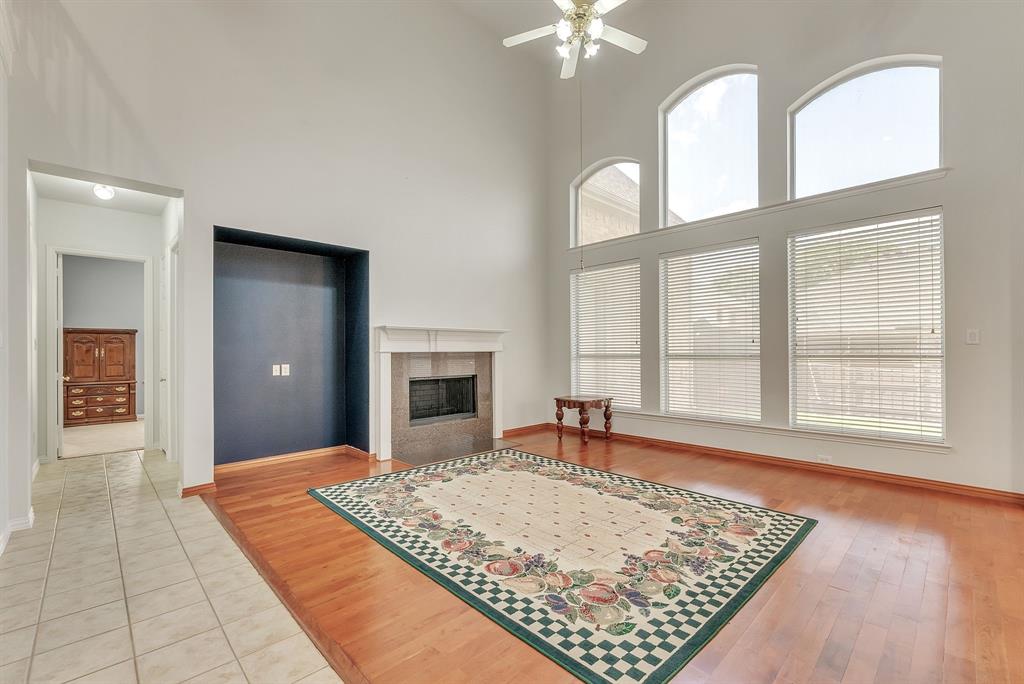 1611 Long Prairie Court Allen, TX 75002 - Photo 9 of 32 a view of an empty room with chandelier and a rug