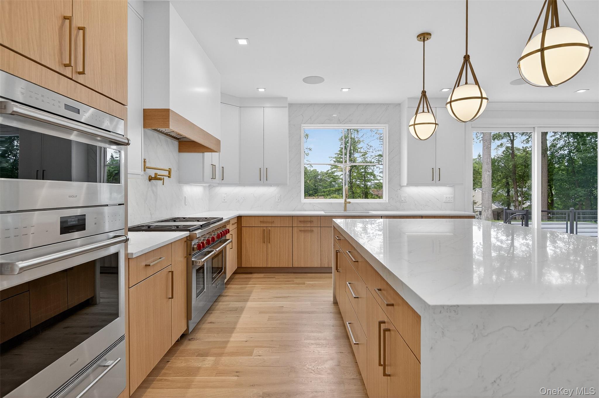 32 A Pine Road Syosset, NY 11791 - Photo 16 of 46 a kitchen with stainless steel appliances granite countertop a stove and a large window