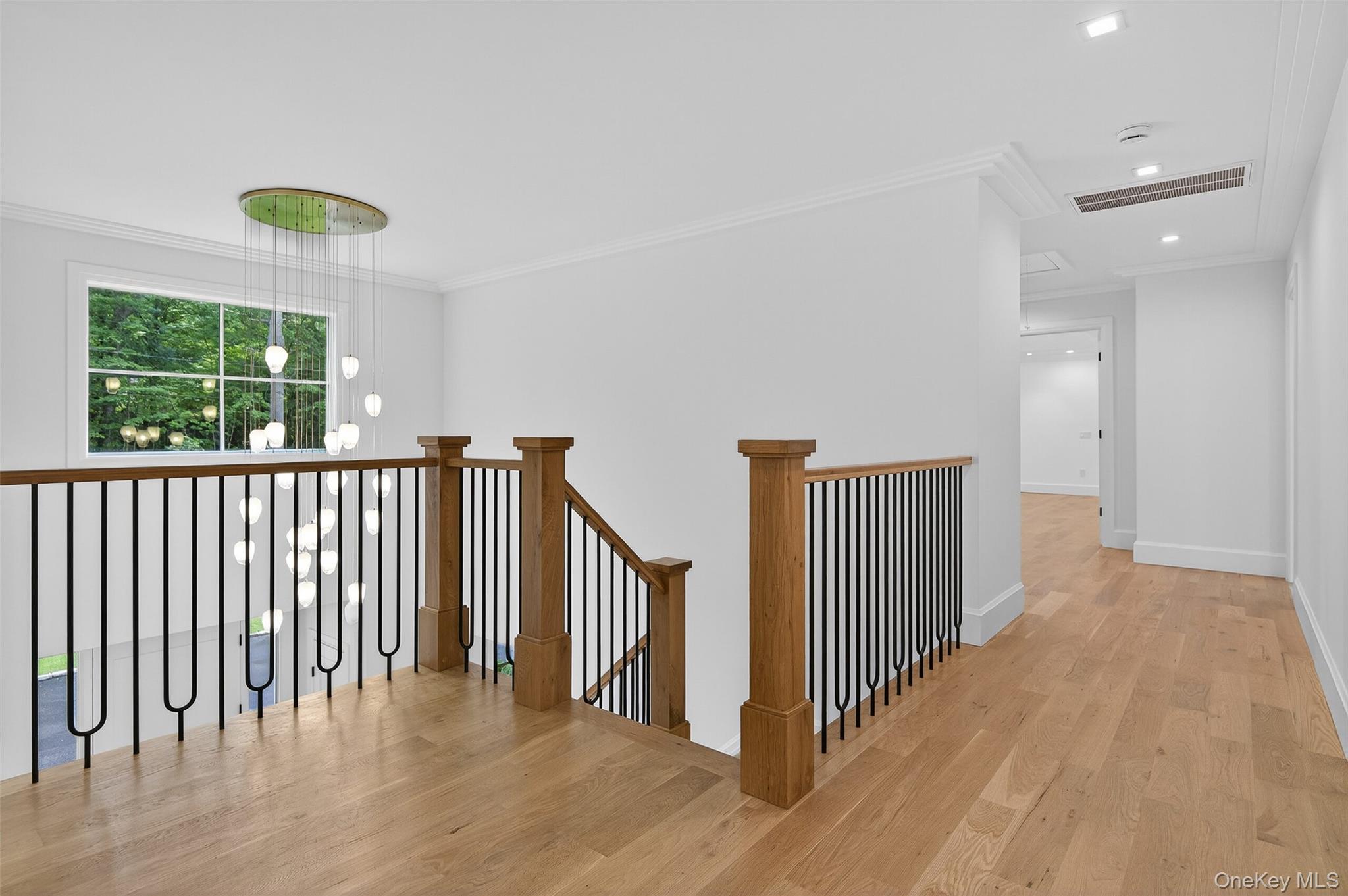 32 A Pine Road Syosset, NY 11791 - Photo 23 of 46 a view of a hallway with wooden floor and windows