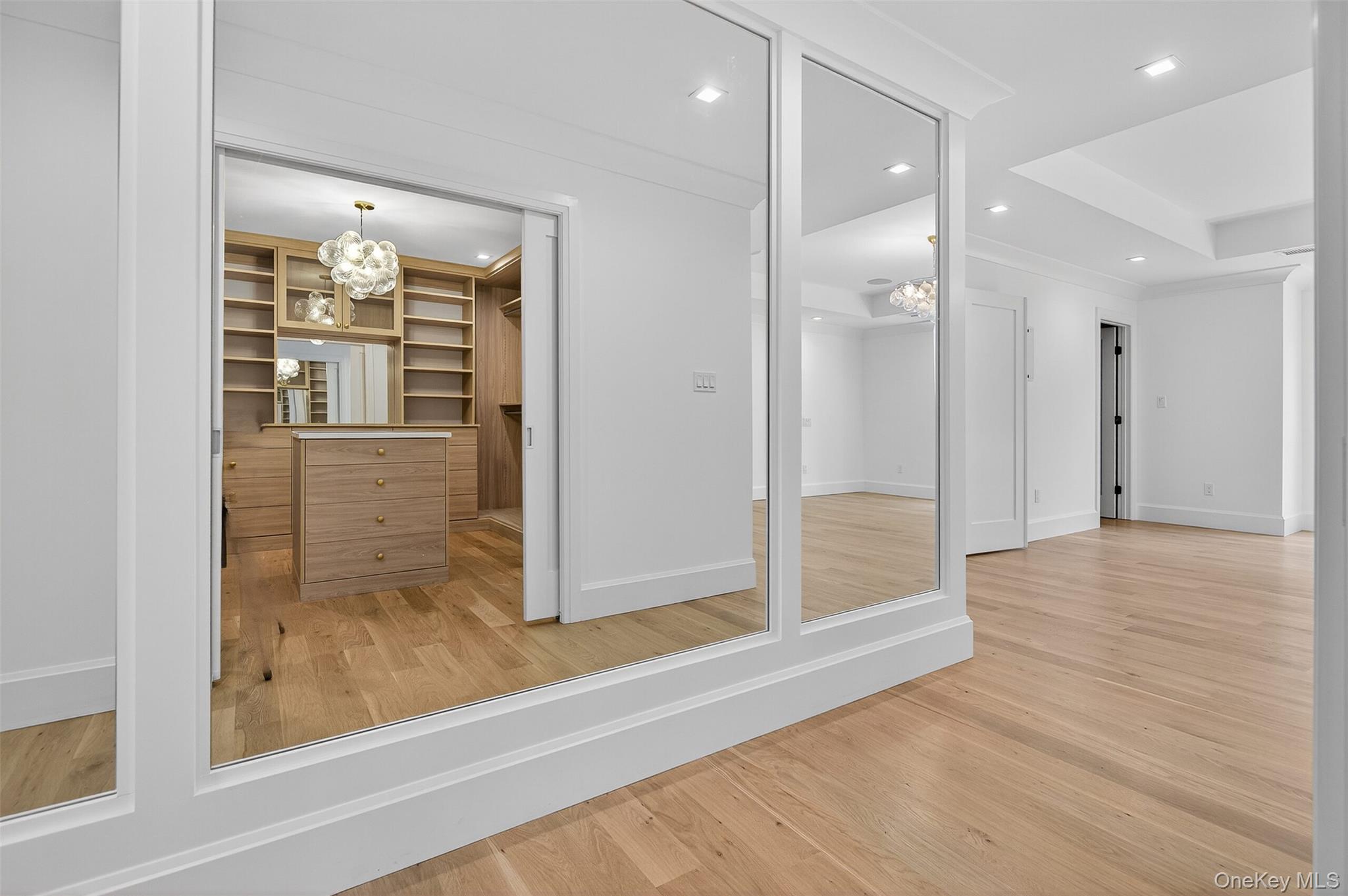 32 A Pine Road Syosset, NY 11791 - Photo 28 of 46 a view of a hallway with wooden floor and staircase