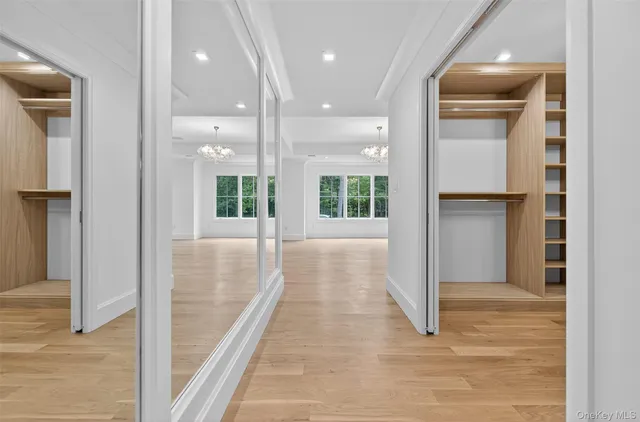 an aerial view of a house with swimming pool and large trees