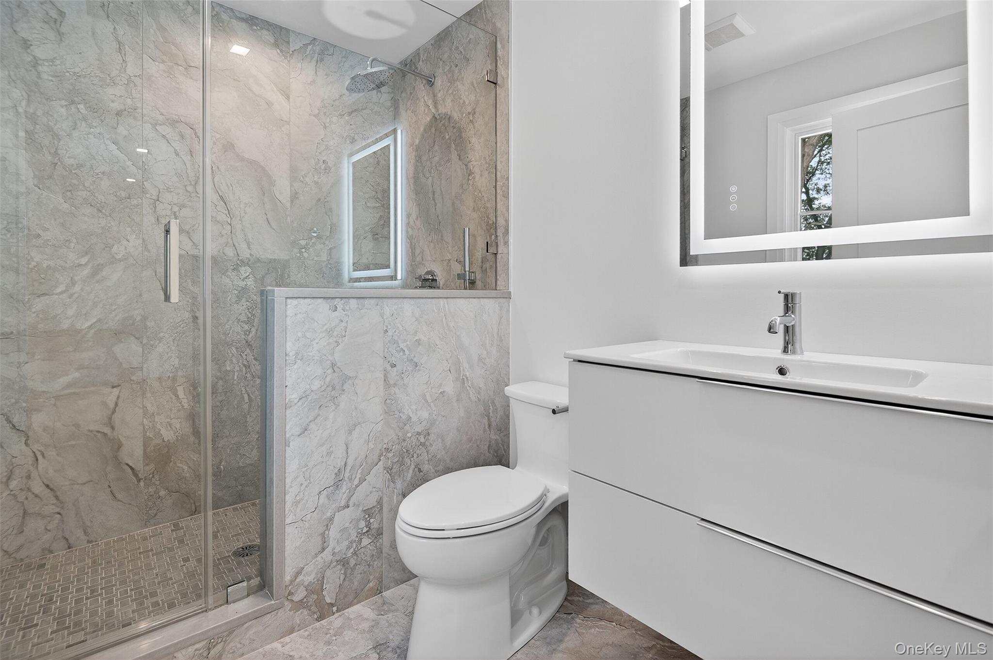 32 A Pine Road Syosset, NY 11791 - Photo 34 of 46 a bathroom with a toilet sink and shower