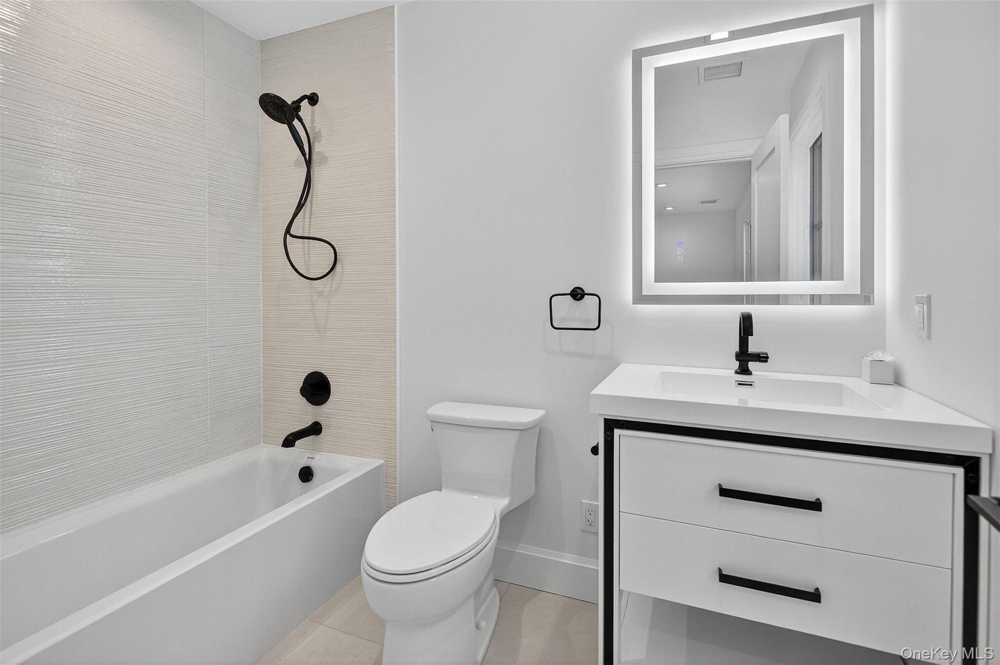 32 A Pine Road Syosset, NY 11791 - Photo 36 of 46 a bathroom with a sink a toilet and a bathtub