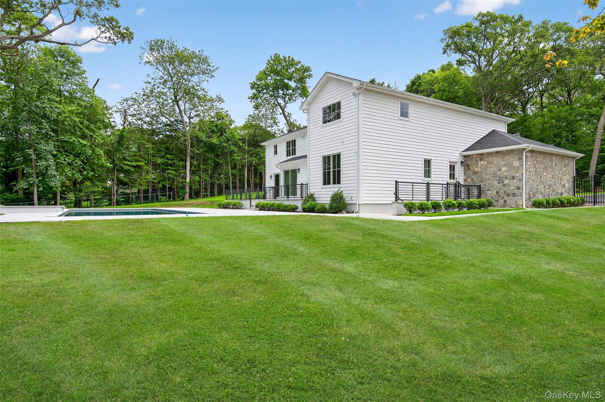 32 A Pine Road Syosset, NY 11791 - Photo 46 of 46 a backyard of a house with lots of green space and garden