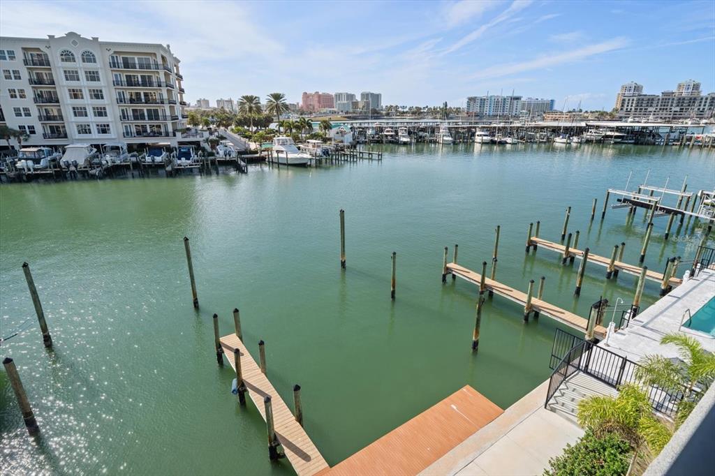 211 Dolphin Point, Unit 2 Clearwater, FL 33767 - Photo 10 of 16 a view of a lake with boats and trees in the background