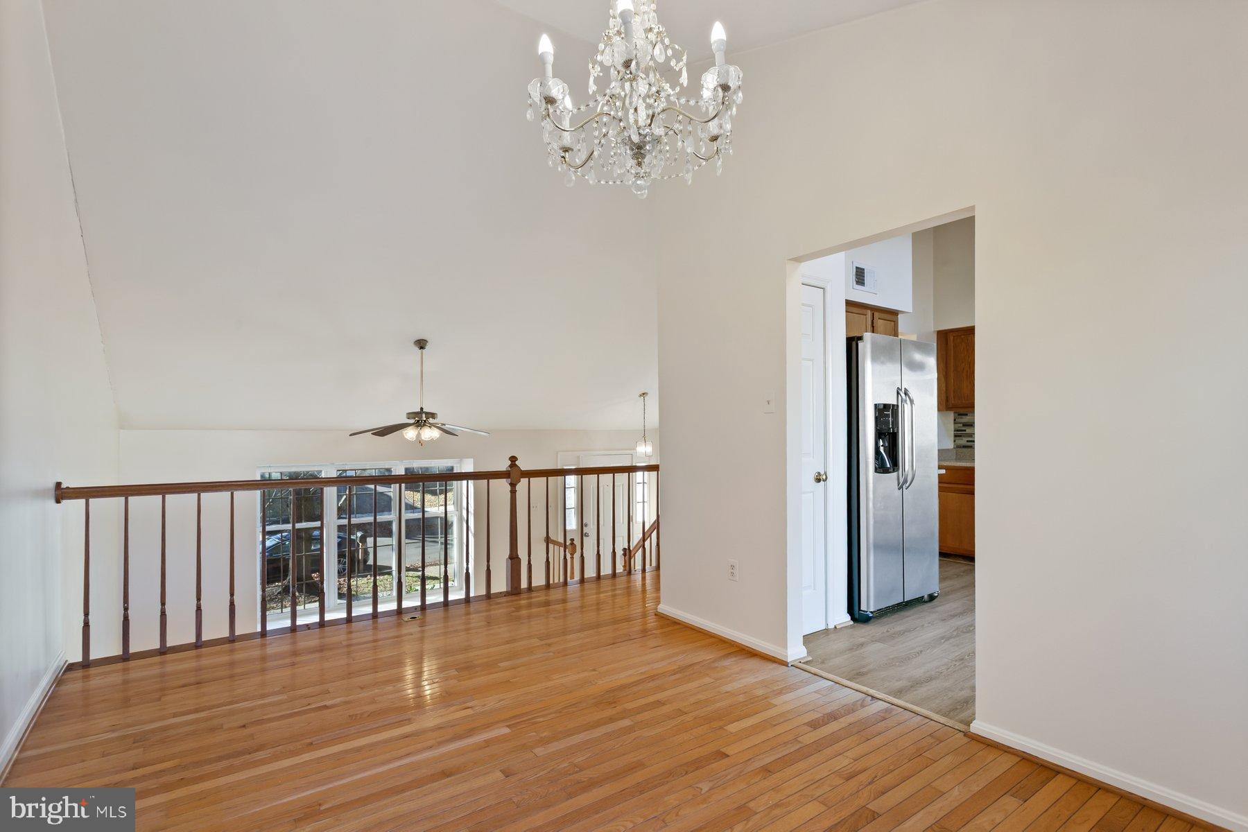 12907 Hawkshead Terrace Silver Spring, MD 20904 - Photo 12 of 30 a view of a hallway with wooden floor and a chandelier