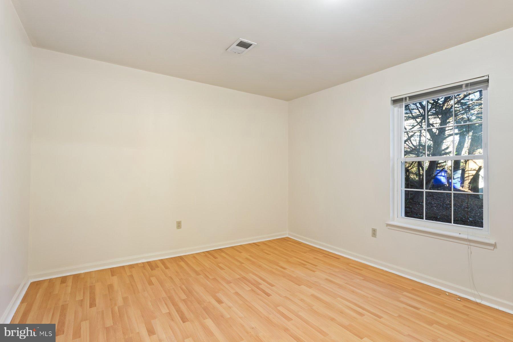 12907 Hawkshead Terrace Silver Spring, MD 20904 - Photo 25 of 30 a view of empty room with wooden floor and fan