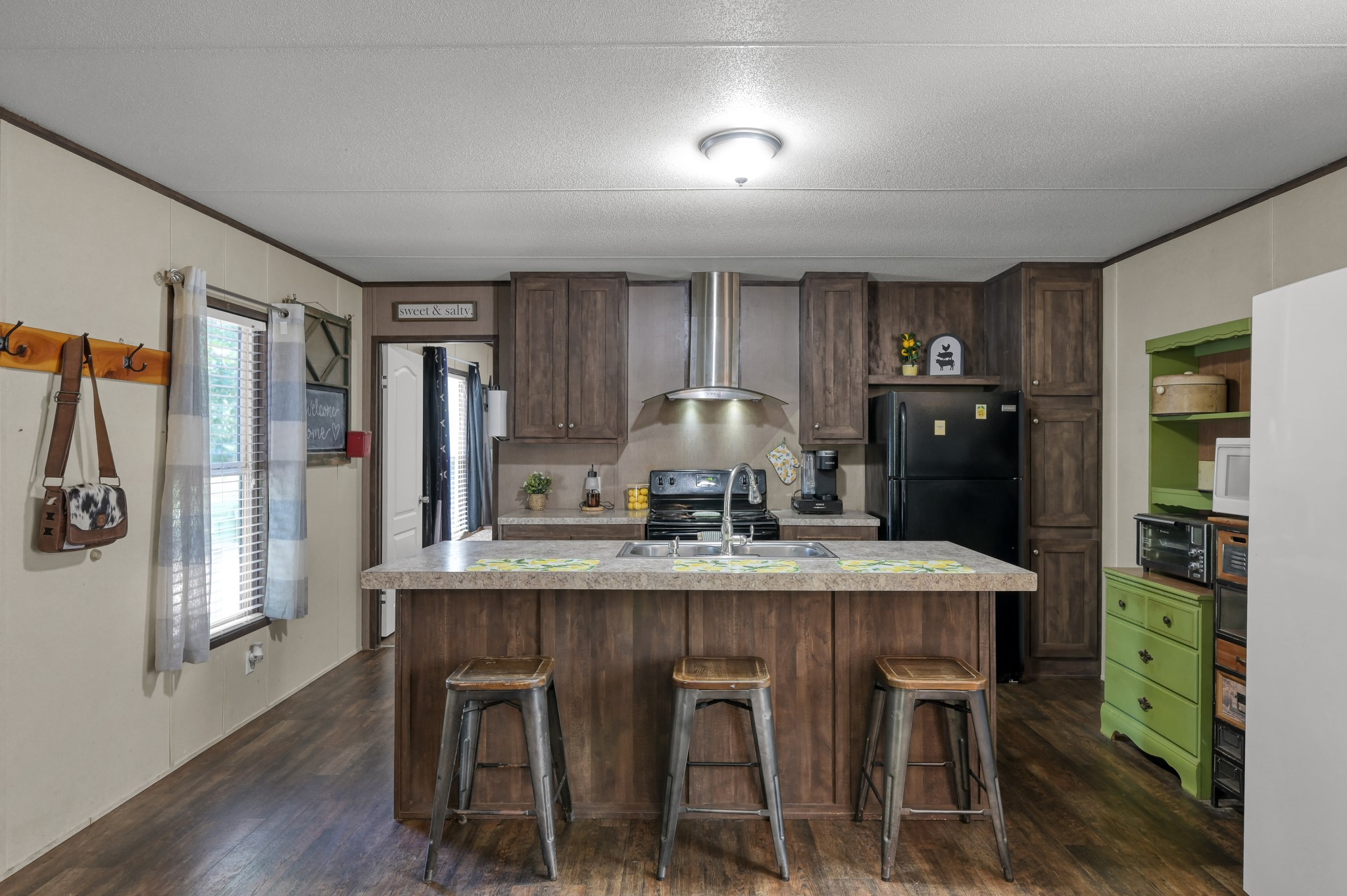 400 Raven Hill Road Oakhurst, TX 77359 - Photo 15 of 45 a kitchen with stainless steel appliances granite countertop a dining table chairs refrigerator and sink