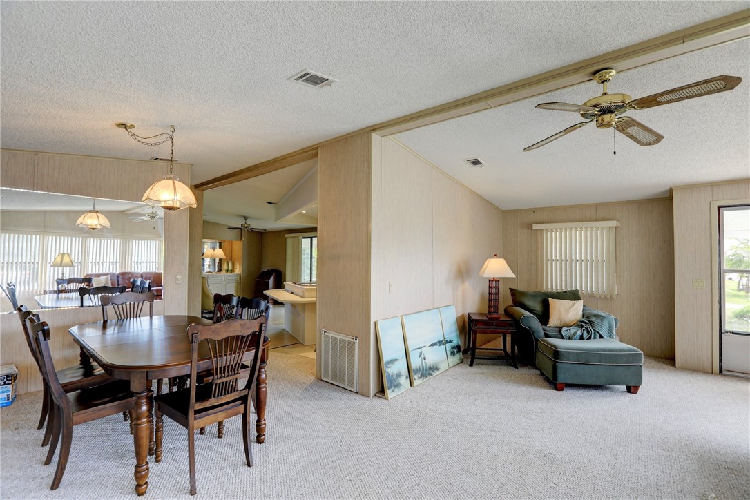 1064 Manila Drive Sebastian, FL 32976 - Photo 3 of 25 a view of a livingroom and a dining room with furniture window and wooden floor