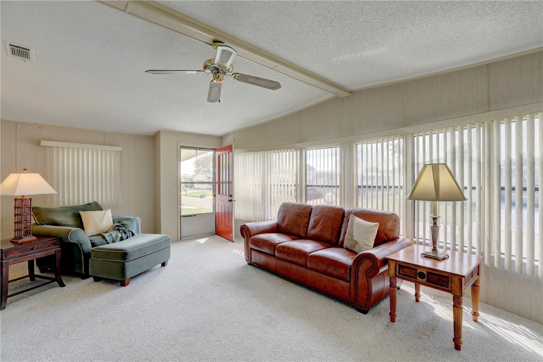 1064 Manila Drive Sebastian, FL 32976 - Photo 4 of 25 a living room with furniture a ceiling fan and a large window