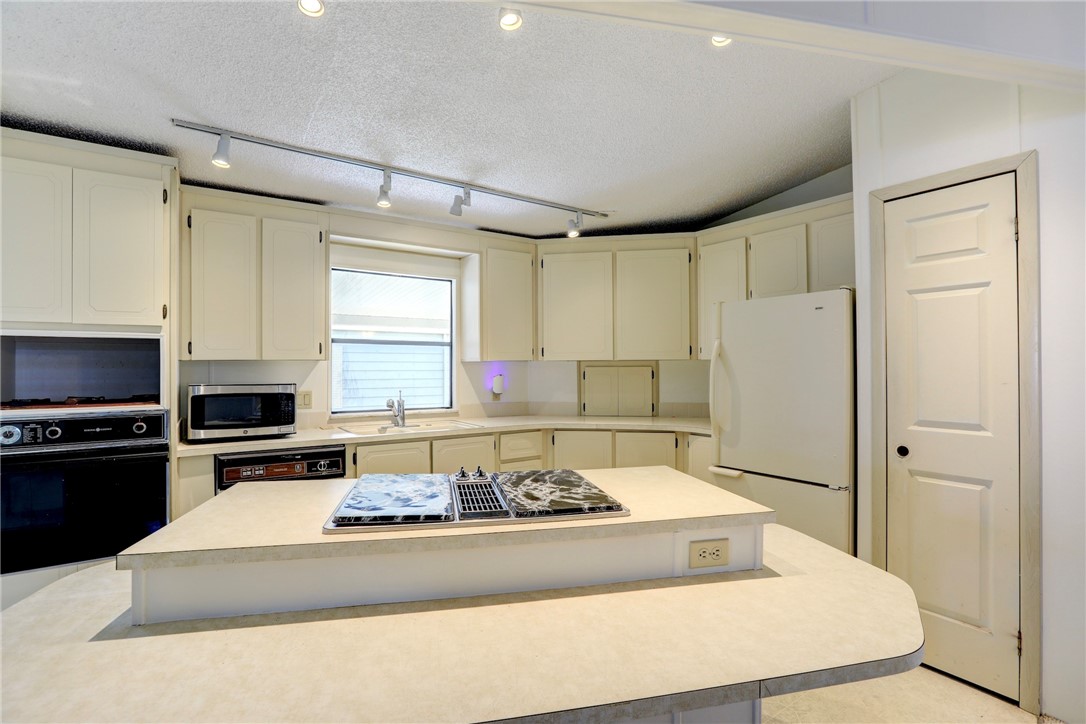 1064 Manila Drive Sebastian, FL 32976 - Photo 8 of 25 a kitchen with a appliances a sink and a refrigerator