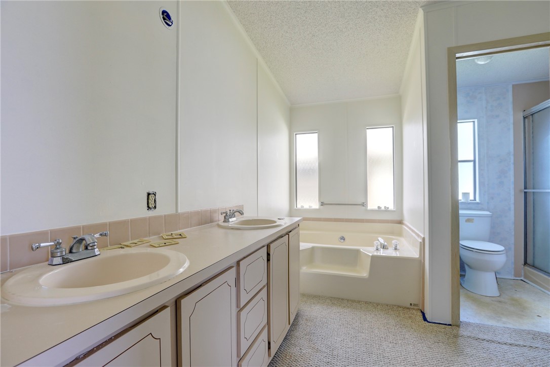 1064 Manila Drive Sebastian, FL 32976 - Photo 10 of 25 a bathroom with a sink a toilet and a tub