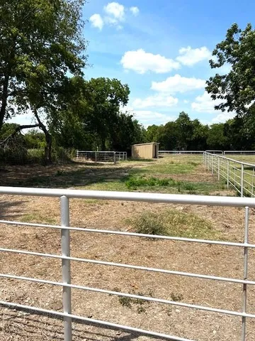 a view of a house with a yard and tree