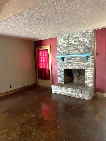 a view of empty room with a fireplace