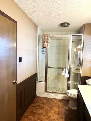 a bathroom with a sink vanity mirror and toilet